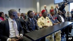 Plaintiffs Alali Efanga, Friday Alfrad Akpan, Chief Fidelis A. Oguru, Eric Dooh, and lawyer Chima Williams wait for the start of a court case against Shell, in The Hague, October 11, 2012.