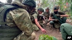 In this photo taken taken from video distributed by Russian Defense Ministry Press Service on Oct. 8, 2024, Russian soldiers attend combat training for assault units at an undisclosed location during a special military operation in Ukraine.