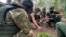 In this photo taken taken from video distributed by Russian Defense Ministry Press Service on Oct. 8, 2024, Russian soldiers attend combat training for assault units at an undisclosed location during a special military operation in Ukraine.