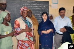 Pakistani activist Malala Yousafzai, center right, visits a school in Maiduguri, Nigeria, July. 18, 2017. The Nobel Peace laureate spoke out for the many girls abducted under Boko Haram's deadly insurgency.
