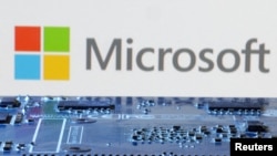 FILE - Microsoft logo is seen near computer motherboard in this illustration taken January 8, 2024. 