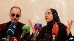 The mother of the two Boston bombing suspects, Zubeidat Tsarnaeva, with the suspects' father Anzor Tsarnaev, left, speaks at a news conference in Makhachkala, the southern Russian province of Dagestan, April 25, 2013.