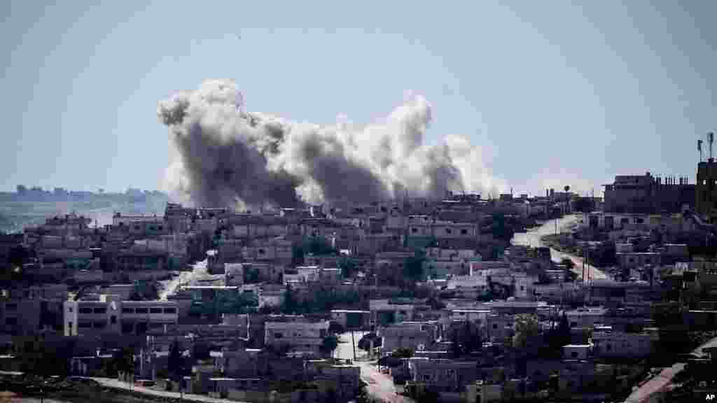 Smoke rises from buildings after an airstrike hit in Habit village, Hama, Syria, Sep. 25, 2013.