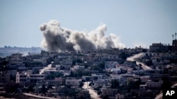 Smoke rises from buildings after an airstrike hit in Habit village, Hama, Syria, Sep. 25, 2013.