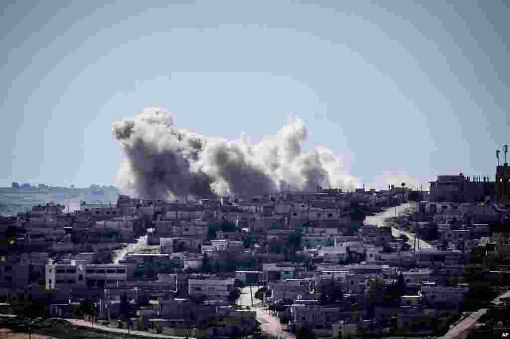 Smoke rises from buildings after an airstrike hit in Habit village, Hama, Syria, Sep. 25, 2013.