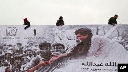 Afghans erect an election poster of presidential election candidate, Abdullah Abdullah in Kabul, Afghanistan, Feb. 2, 2014. 