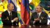 Russia's President Vladimir Putin, left, and Cuba's President Raul Castro applaud at Revolution Palace in Havana, Cuba, July 11, 2014.