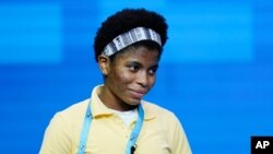 Zaila Avant-garde, 14, from Harvey, Louisiana, reacts after correctly spelling a word during the finals of the 2021 Scripps National Spelling Bee at Disney World, July 8, 2021, in Lake Buena Vista, Fla.