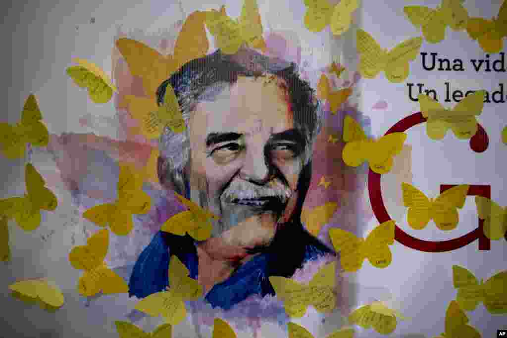 A placard of Nobel Prize-winning novelist Gabriel Garcia Marquez is surrounded by yellow butterfly cutouts with messages, placed there by fans, at a bookstore in Mexico City. Marquez fans are commemorating the first anniversary of his death. In 'Gabo's renowned novel "100 Years of Solitude," clouds of yellow butterflies precede a forbidden lover’s arrival.
