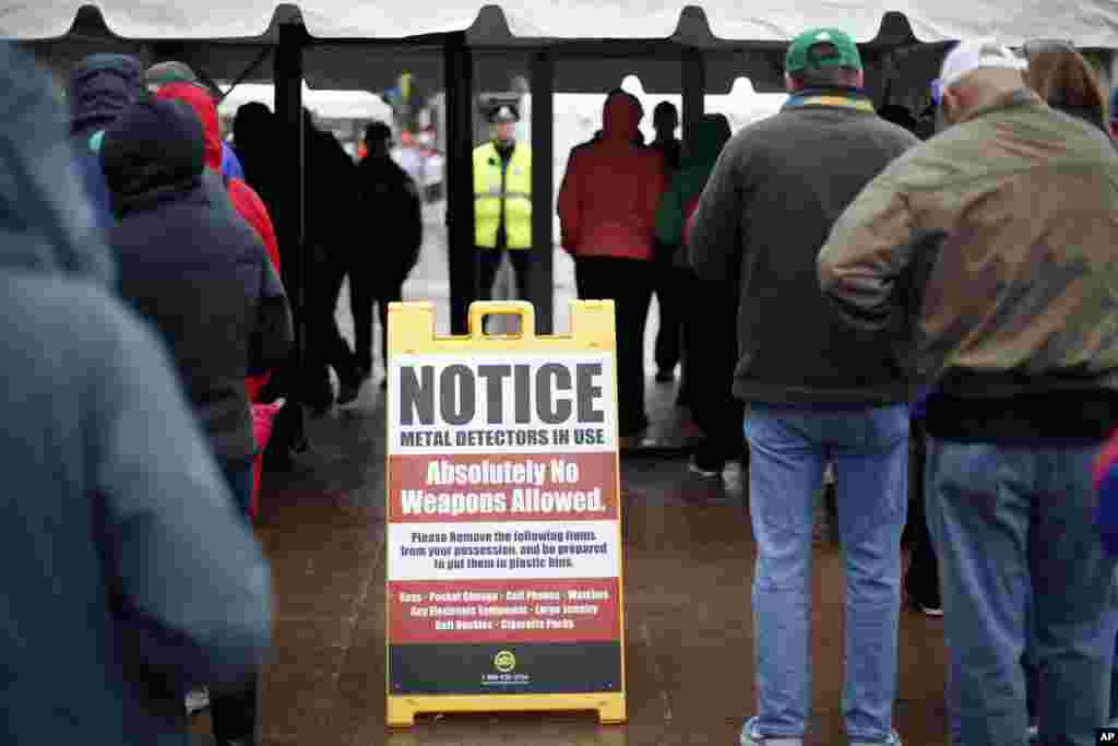 Spectators pass through a security checkpoint near the finish line of the Boston Marathon, Boston, April 20, 2015