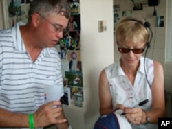 White Sox organist Nancy Faust autographs a baseball cap for a fan.