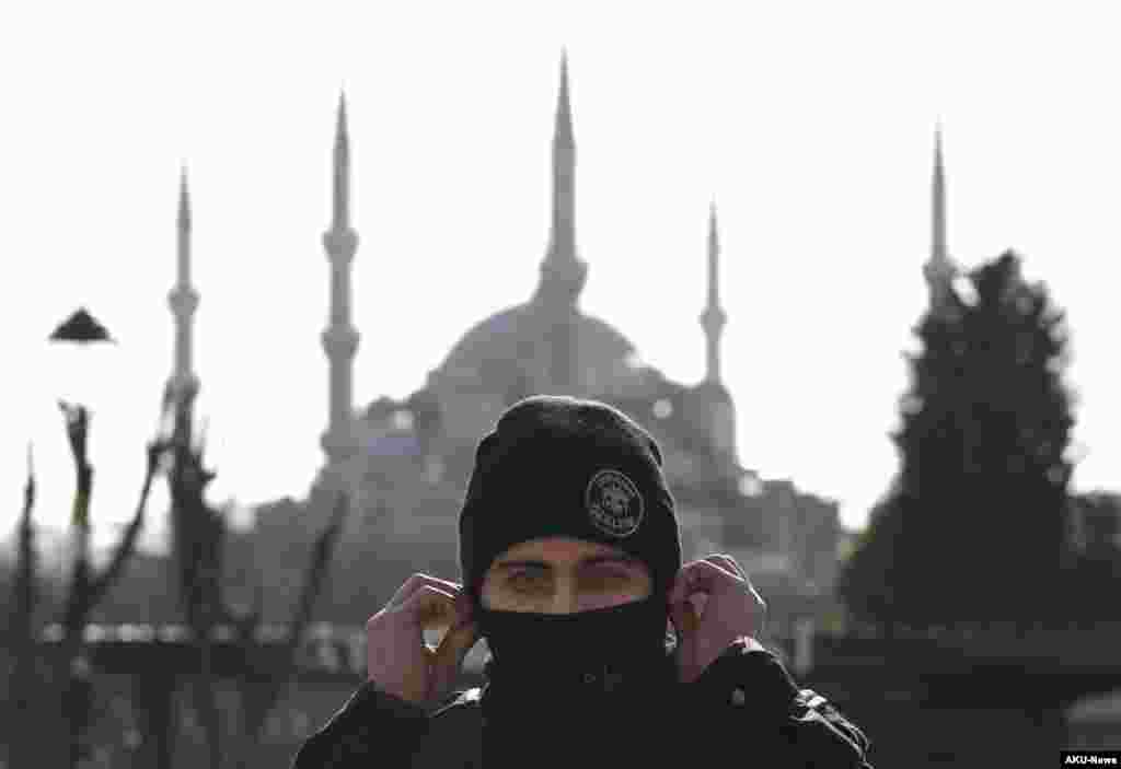 Standing in front of the Sultan Ahmed Mosque, better known as the Blue Mosque in the historic Sultanahmet district of Istanbul, a police officer secures the area after an explosion, Jan. 12, 2016