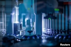 Vials of coronavirus disease (COVID-19) vaccine candidate BNT162b2 are inspected at a Pfizer manufacturing site in Kalamazoo, Michigan, U.S. in an undated photograph. (Pfizer/Handout via REUTERS)