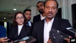 Ramkarpal Singh, far right and Sangeet Kaur Deo, far left, lawyers of the family of a murdered Mongolian model Altantuya Shaariibuu, speaks to the press in Shah Alam, Malaysia, Wednesday, Jan. 23, 2019. 