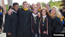 FILE -- Friends pose together at their graduation from Merrimack College in North Andover, Massachusetts. (Photo by Flickr user Merrimack College via Creative Commons license)