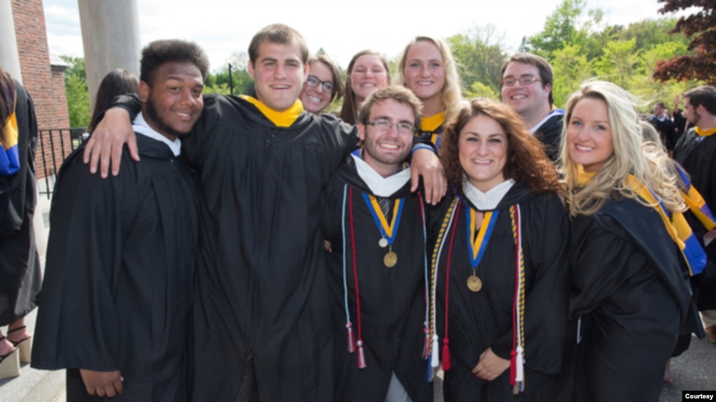 FILE -- Friends pose together at their graduation from Merrimack College in North Andover, Massachusetts. (Photo by Flickr user Merrimack College via Creative Commons license.)