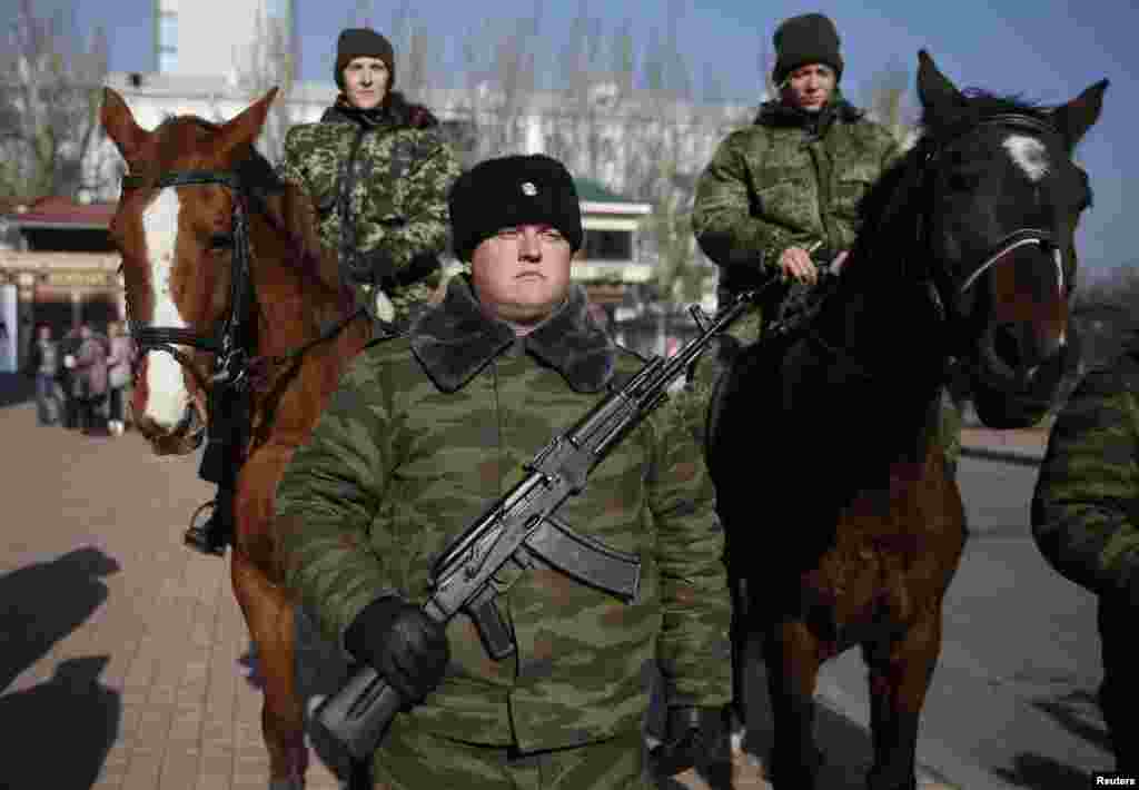 Members of an honor guard wait for the arrival of pro-Russian rebel leader Alexander Zakharchenko in front of a theater in Donetsk, Ukraine, Nov. 4, 2014. 