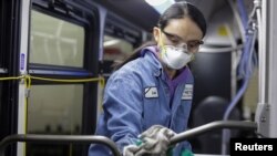 Vehicle Maintenance Utility Service Worker Thiphavanh 'Loui' Thepvongsa wipes down an off-duty bus with a disinfectant during a routine cleaning at the King County Metro Atlantic and Central Base in Seattle, Washington, U.S. March 2, 2020.