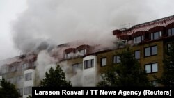 Smoke comes out of windows after an explosion hit an apartment building in Annedal, central Gothenburg, Sweden, Sept. 28, 2021.