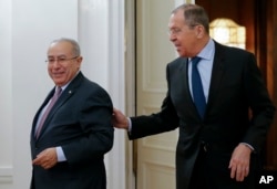 Russian Foreign Minister Sergey Lavrov, right, welcomes Algeria's Deputy Prime Minister Ramtane Lamamra for talks in Moscow, Russia, March 19, 2019.