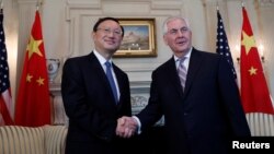 U.S. Secretary of State Rex Tillerson greets Chinese State Councilor Yang Jiechi at the State Department in Washington.