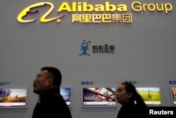 FILE - A sign of Alibaba Group is seen during the fourth World Internet Conference in Wuzhen, Zhejiang province, China, Dec. 3, 2017.