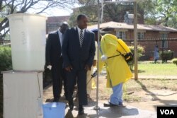 Zimbabwe's new health minister, Obadiah Moyo, arrives at Beatrice Infectious Diseases Hospital, where cholera patients are being treated, in Harare, Sept. 11, 2018. (C. Mavhunga/VOA)