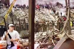 Kenya - Rescuers working to help survivors amid the devastation brought in by a bomb explosion near the US embassy in Nairobi, August 7, 1998.