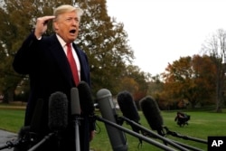 President Donald Trump talks to the media before boarding Marine One on the South Lawn of the White House, Nov. 9, 2018, in Washington.