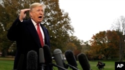 FILE - President Donald Trump talks to the media before boarding Marine One on the South Lawn of the White House, Nov. 9, 2018, in Washington.