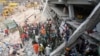 Firefighters, army and locals try to rescue garment workers, who are trapped inside the rubble of the collapsed Rana Plaza building, in Savar, 30 km (19 miles) outside Dhaka April 25, 2013. The number of people killed by the collapse of a building in Ban