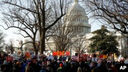 Protesters demonstrate as the House of Representatives begins debate on the articles of impeachment against President Donald Trump at the U.S. Capitol building, Wednesday, Dec. 18, 2019, on Capitol Hill in Washington. (AP Photo/Matt Rourke)