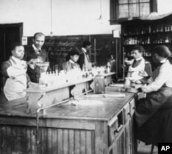 George Washington Carver oversees the work of some of his botany students.