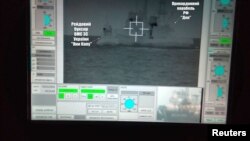 A screen shows a Russian border guard vessel Don trying to stop a Ukrainian Navy tug boat as three Ukrainian ships make a journey from the Black Sea port of Odessa via the Kerch Strait to Mariupol on the Sea of Azov, in the Black Sea, Nov. 25, 2018.