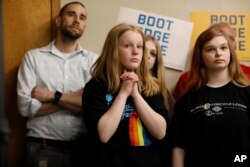 Audience members listen as 2020 Democratic presidential candidate South Bend Mayor Pete Buttigieg speaks during a town hall meeting in Fort Dodge, Iowa, April 16, 2019.