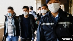 FILE - Pro-democracy activist Lester Shum is taken away by police officers as more than 50 Hong Kong activists are arrested under a security law in Hong Kong, China January 6, 2021. REUTERS