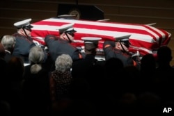 Marines carry John Glenn's casket at the end of his funeral at Ohio State University in Columbus, Dec. 17, 2016.