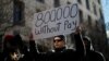 FILE - A demonstrator holds a sign, signifying hundreds of thousands of federal employees who won’t be receiving their paychecks as a result of the partial government shutdown, during a “Rally to End the Shutdown” in Washington, Jan. 10, 2019.