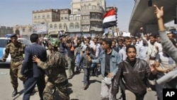 Yemeni police block the way as anti-government protestors attend a rally demanding political reform and the resignation of President Ali Abdullah Saleh in Sanaa, Yemen, February 13, 2011