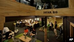 FILE - young Indian entrepreneurs and freelancers work inside Innov8, a lax co-working space in New Delhi, India. 