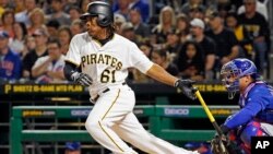 Pittsburgh Pirates' Gift Ngoepe, a native of South Africa, and the first baseball player from the continent of Africa to play in the Major Leagues, hits a single off Chicago Cubs starting pitcher Jon Lester in his first at-bat in the fourth inning of a baseball game in Pittsburgh, April 26, 2017. 
