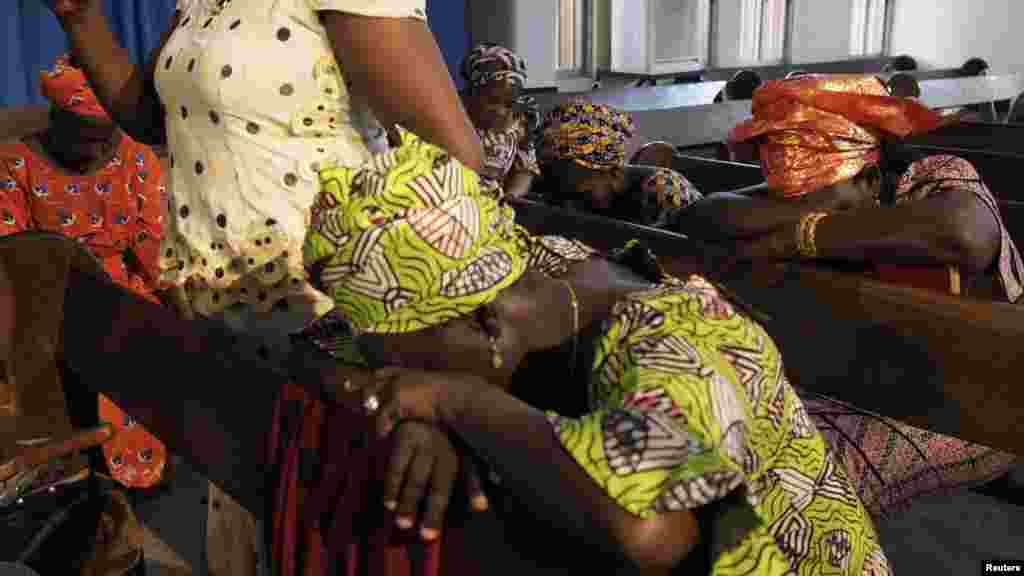 Churchgoers pray for the release of secondary school girls abducted from in the remote village of Chibok, at an Evangelical Church of West Africa (ECWA) church in Abuja May 11, 2014.