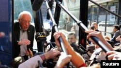 FILE - U.S. Democratic presidential candidate Bernie Sanders speaks to reporters from his bus outside his campaign's Iowa headquarters in Des Moines, Iowa, Feb. 1, 2016.