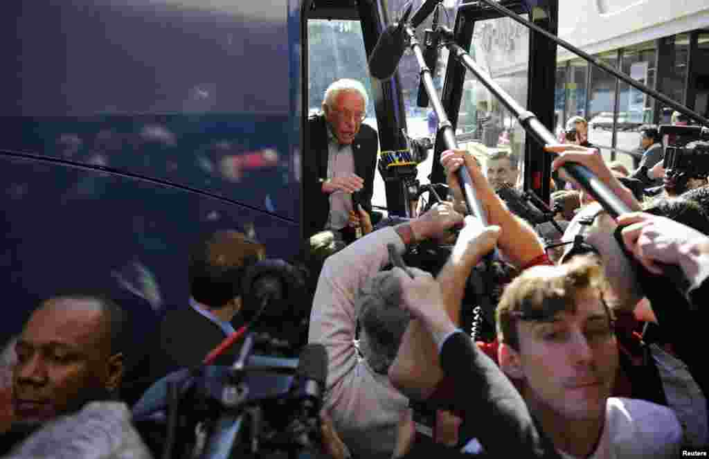 U.S. Democratic presidential candidate Bernie Sanders speaks to reporters from his bus outside his campaign's Iowa headquarters in Des Moines, Iowa, Feb. 1, 2016.