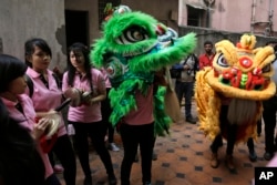 Members of the Chinese community perform lion and dragon dance on a street as they mark Chinese New Year in Kolkata, India, Feb. 8, 2016.