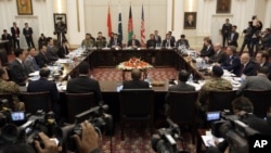 FILE - Delegations from Afghanistan, Pakistan, The United States of America and China discuss a road map for ending the war with the Taliban at the Presidential Palace in Kabul, Afghanistan, Jan. 18, 2016. 