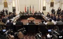 FILE - Delegations from Afghanistan, Pakistan, the United States of America and China discuss a road map for ending the war with the Taliban at the Presidential Palace in Kabul, Afghanistan, Jan. 18, 2016.