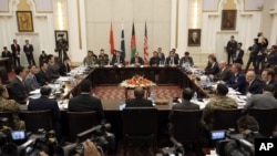 FILE - Delegations from Afghanistan, Pakistan, the U.S. and China discuss a road map for ending the war with the Taliban at the Presidential Palace in Kabul, Afghanistan, Jan. 18, 2016. Broader talks are expected to begin Tuesday.