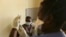 FILE - A young woman prepares to get vaccinated against COVID-19 at a health facility in Harare, Zimbabwe, Sept, 24, 2021.