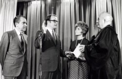 FILE - William Ruckelshaus is sworn in as the first Environmental Protection Agency administrator by Chief Justice Warren Burger as Jill Ruckelshaus and President Richard Nixon look on, Dec. 4, 1970.